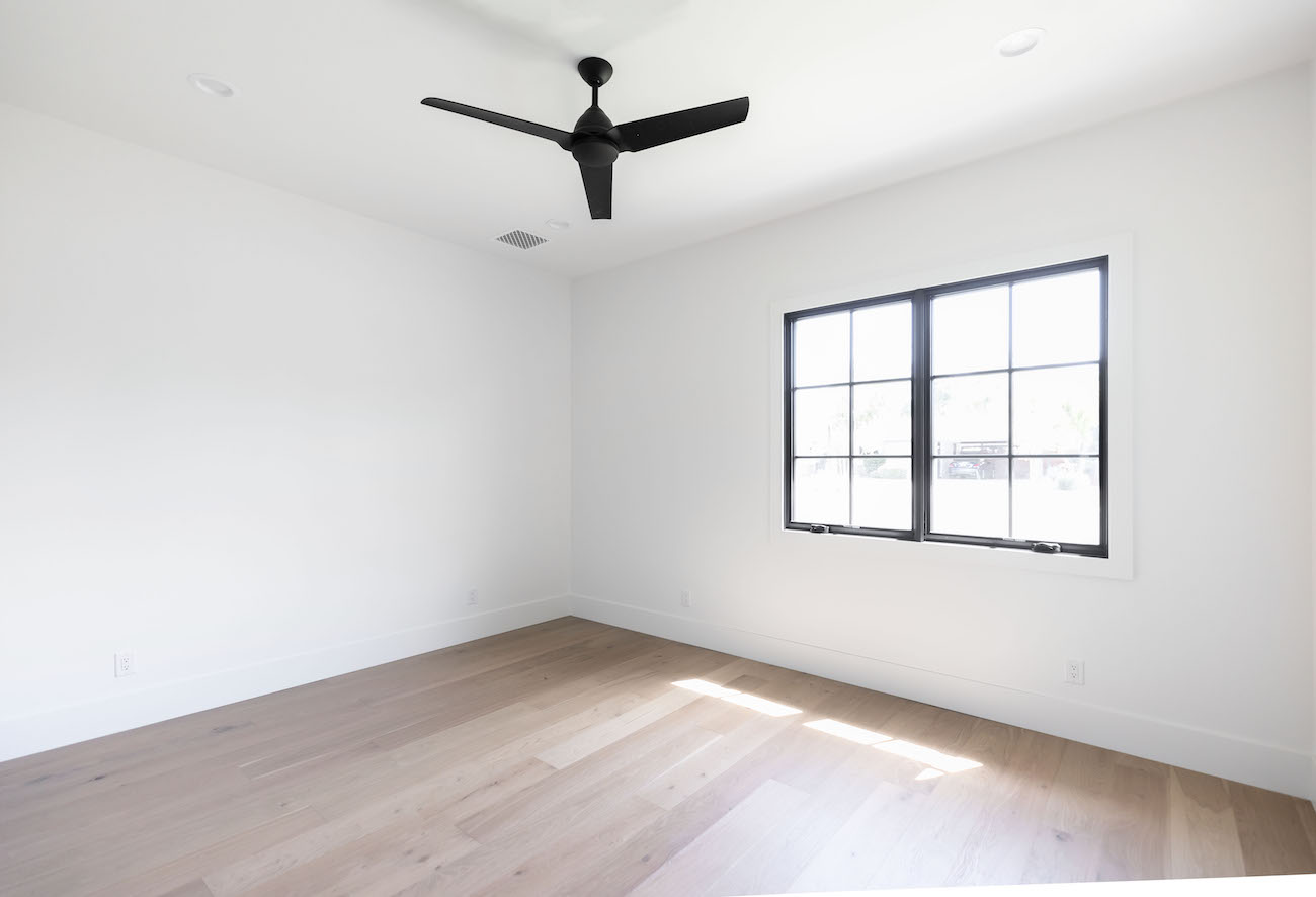 bedroom-layout-wood-floors-black-window-trim